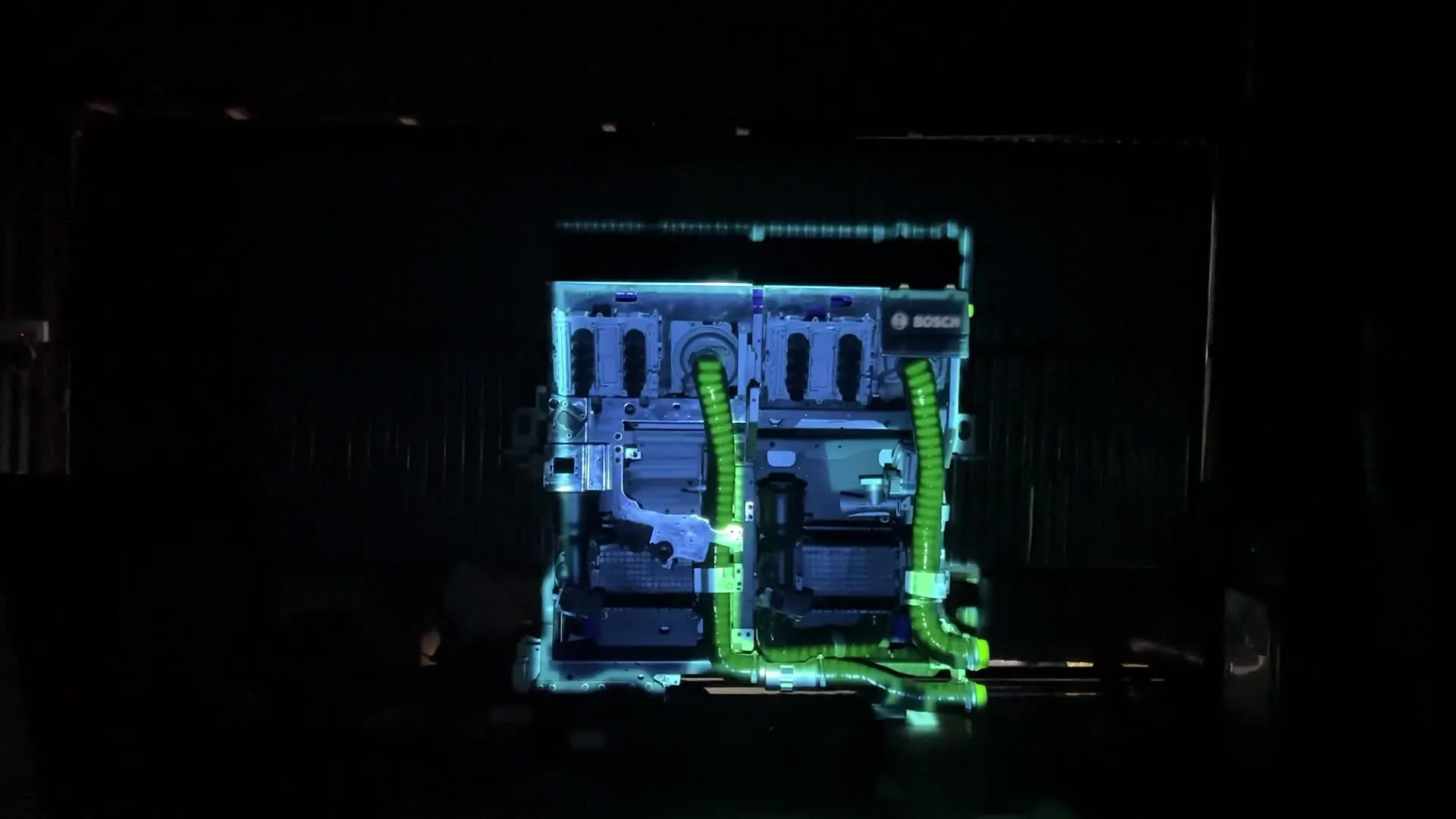 Projection mapping in blue and green light on a full-size engine replica