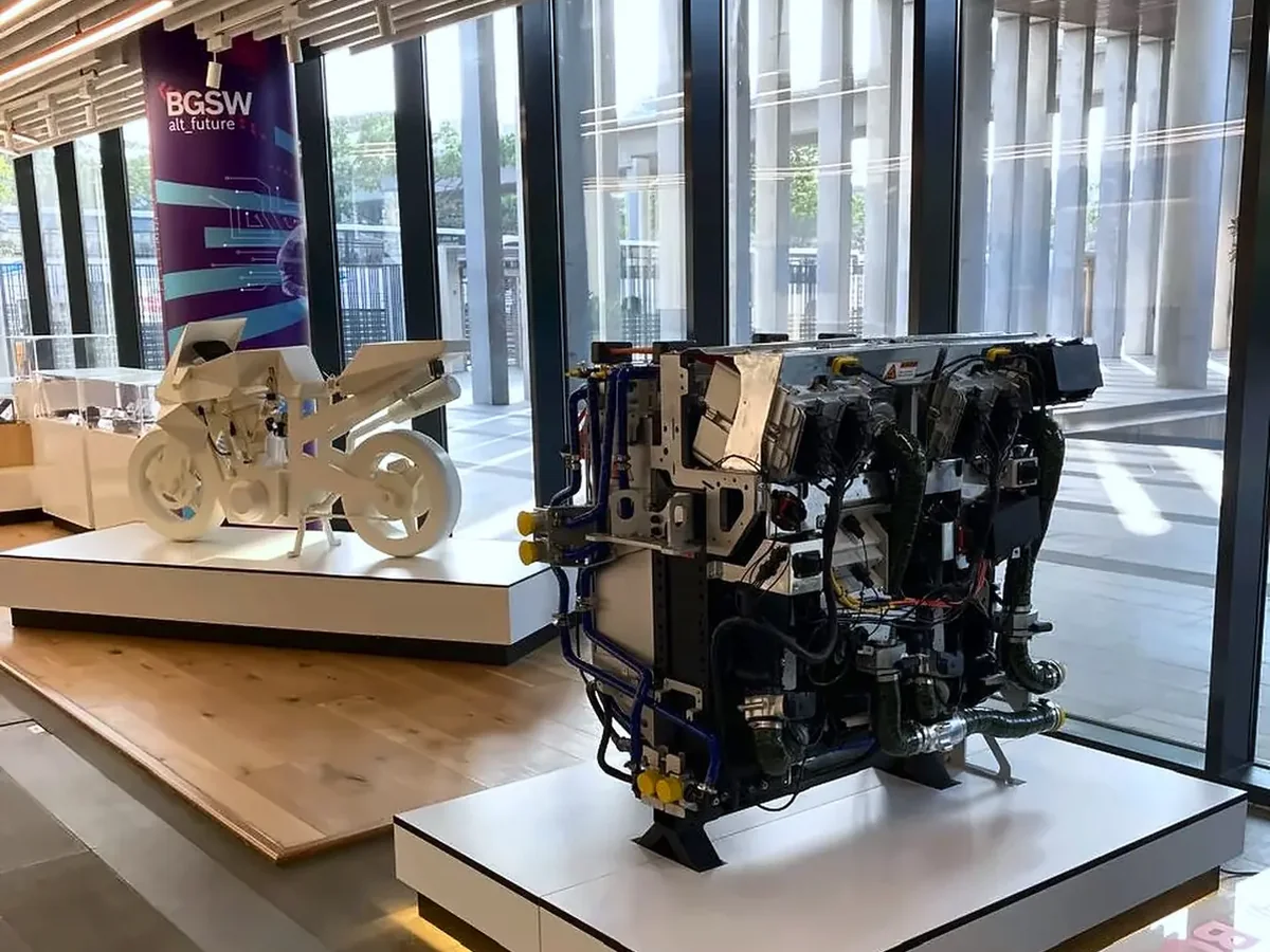 Full-size hydrogen fuel cell engine replica and a motorcycle showpiece on display
