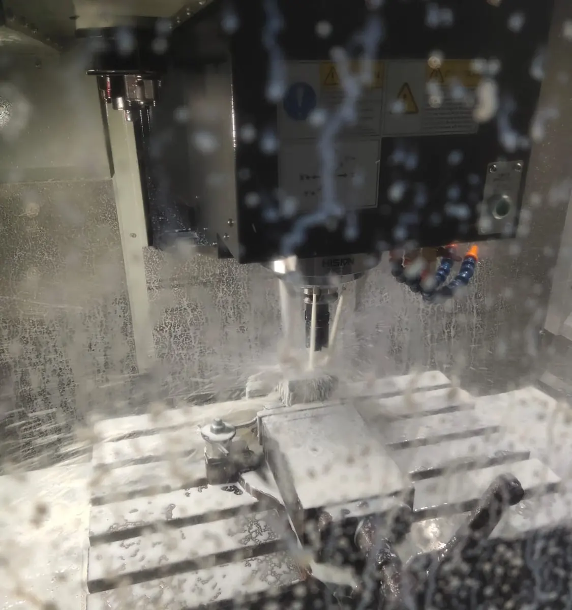 CNC machining of a metal part under coolant